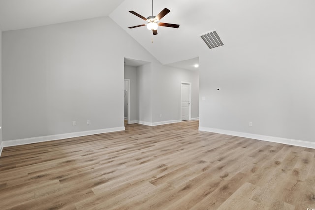 spare room with a ceiling fan, visible vents, baseboards, high vaulted ceiling, and light wood-style flooring