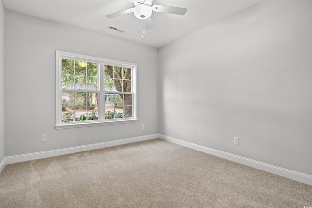 unfurnished room featuring visible vents, ceiling fan, baseboards, and carpet