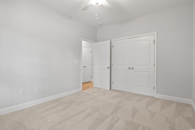 unfurnished bedroom featuring a closet, carpet flooring, ceiling fan, and baseboards