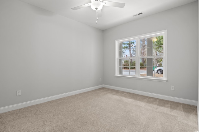 spare room featuring ceiling fan, carpet, visible vents, and baseboards