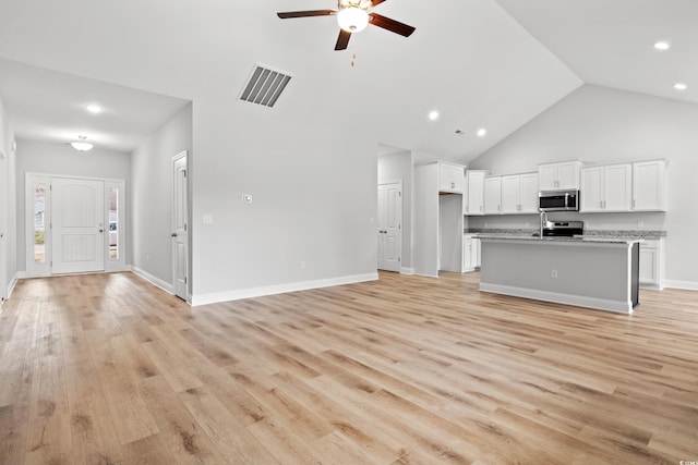 unfurnished living room with visible vents, baseboards, light wood-type flooring, high vaulted ceiling, and a ceiling fan