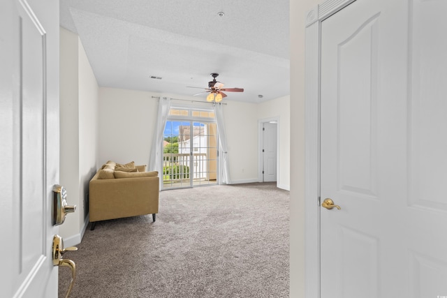 2241 Waterview Dr Unit 437, North Myrtle Beach, SC 29582 - living area featuring carpet, baseboards, a ceiling fan, and a textured ceiling