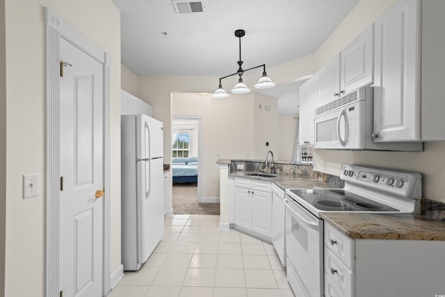 2241 Waterview Dr Unit 437, North Myrtle Beach, SC 29582 - kitchen featuring white appliances, a sink, white cabinetry, a peninsula, and light tile patterned flooring