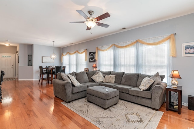 living room featuring hardwood / wood-style flooring and ceiling fan