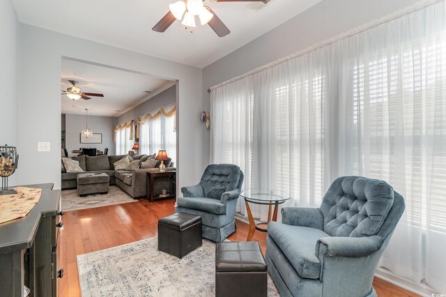 living room featuring ceiling fan and light hardwood / wood-style flooring