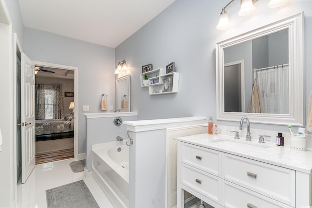 bathroom featuring tile patterned flooring, vanity, a bathtub, and ceiling fan