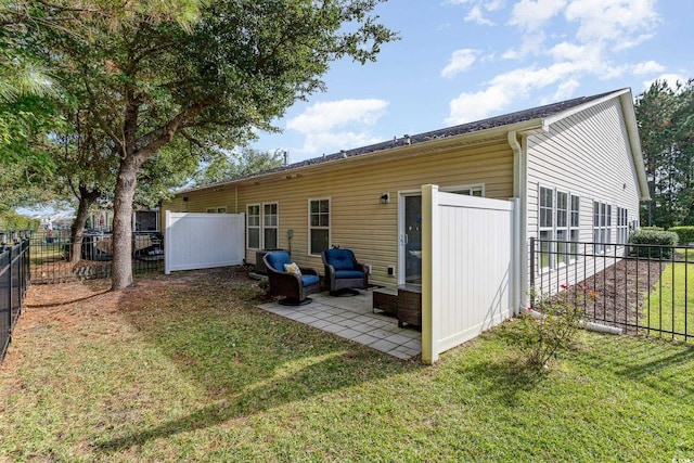 rear view of property featuring outdoor lounge area and a yard