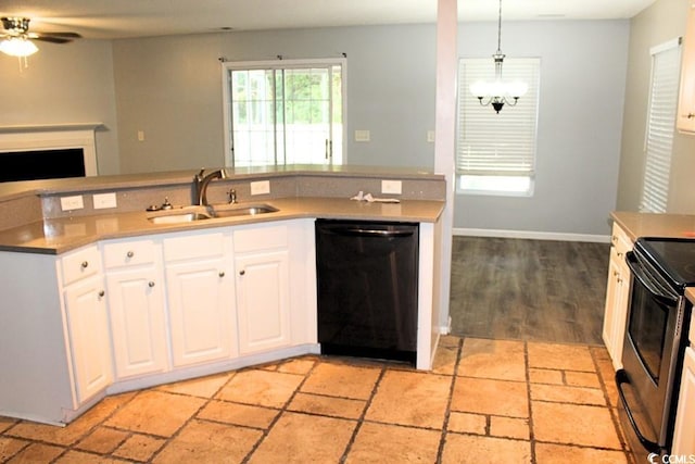 kitchen featuring black appliances, sink, white cabinetry, and hanging light fixtures