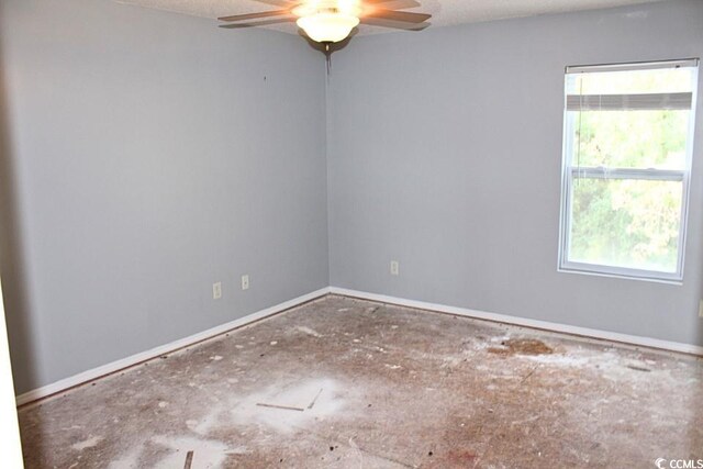 spare room featuring ceiling fan and a textured ceiling