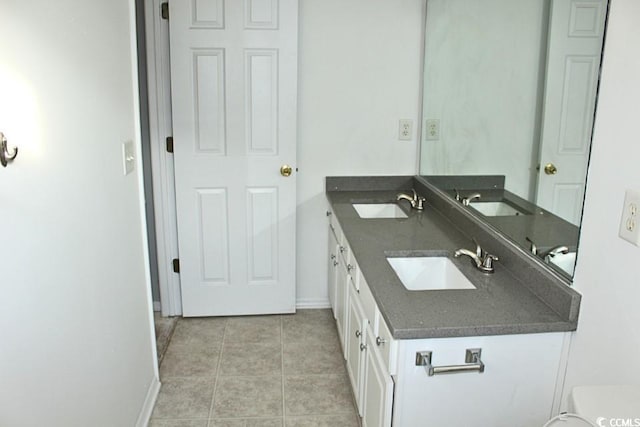 bathroom featuring tile patterned flooring and vanity