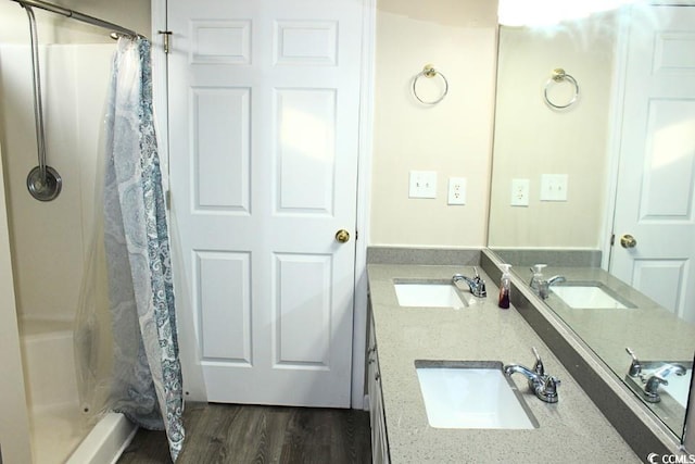 bathroom featuring a shower with curtain, vanity, and wood-type flooring