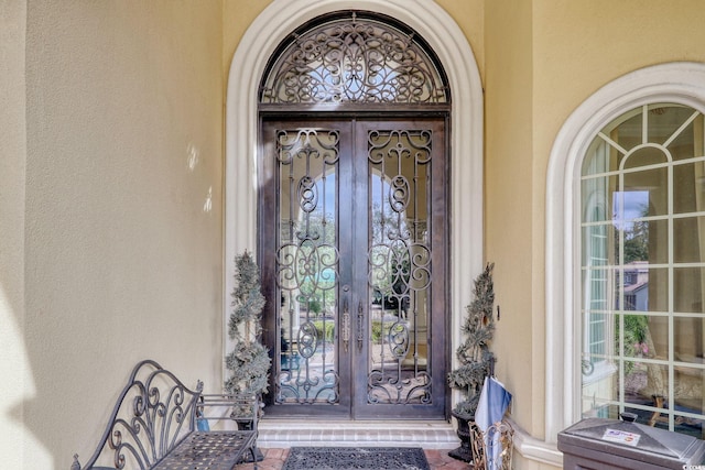 view of exterior entry featuring french doors