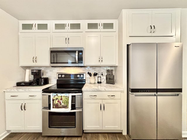 kitchen featuring white cabinetry, stainless steel appliances, and wood-type flooring