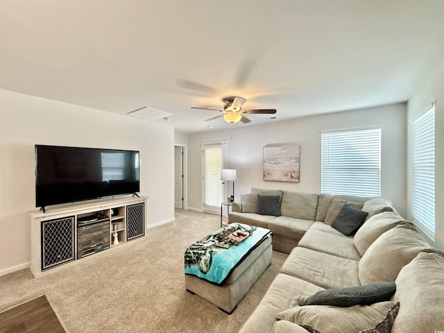 carpeted living room featuring ceiling fan