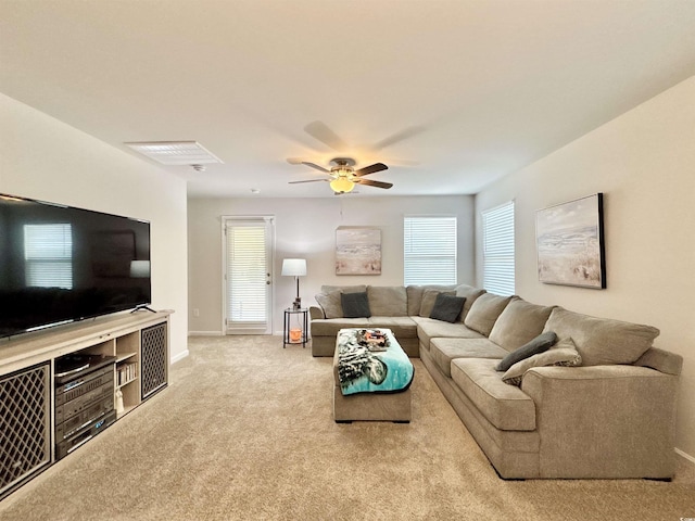 carpeted living room featuring a wealth of natural light and ceiling fan