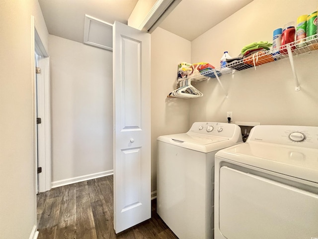 laundry room with dark hardwood / wood-style flooring and washing machine and clothes dryer