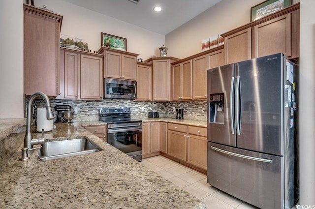 kitchen featuring sink, backsplash, light tile patterned floors, and stainless steel appliances