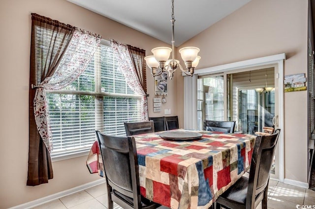 dining space with a notable chandelier, a healthy amount of sunlight, light tile patterned floors, and lofted ceiling