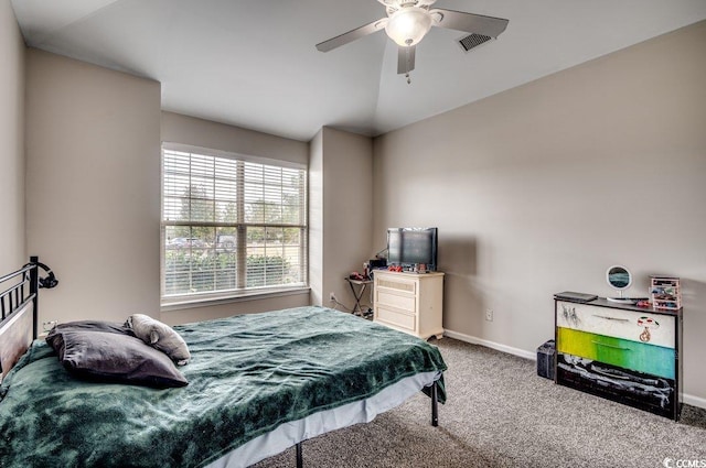 bedroom with ceiling fan, vaulted ceiling, and carpet floors