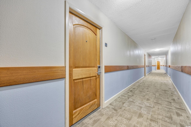 corridor featuring a textured ceiling