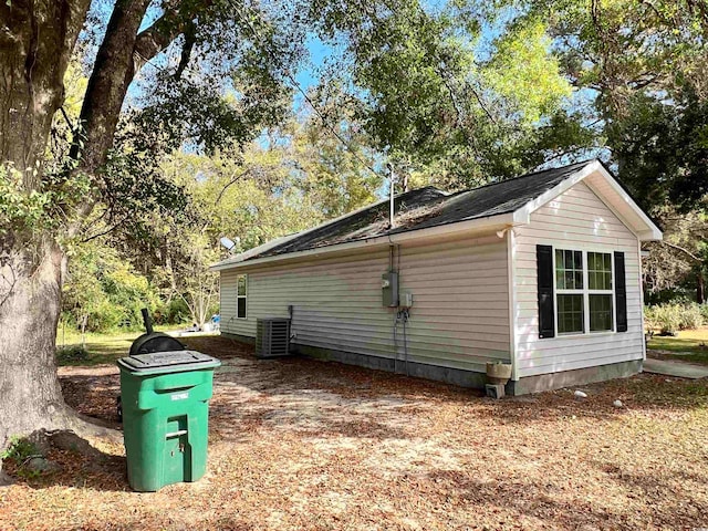 view of side of home with central air condition unit