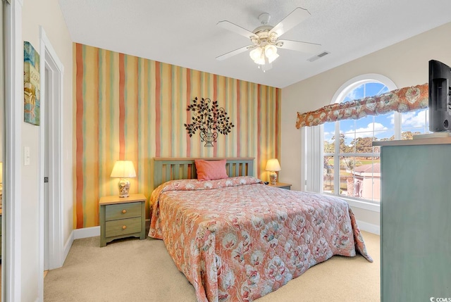 bedroom with light carpet and ceiling fan