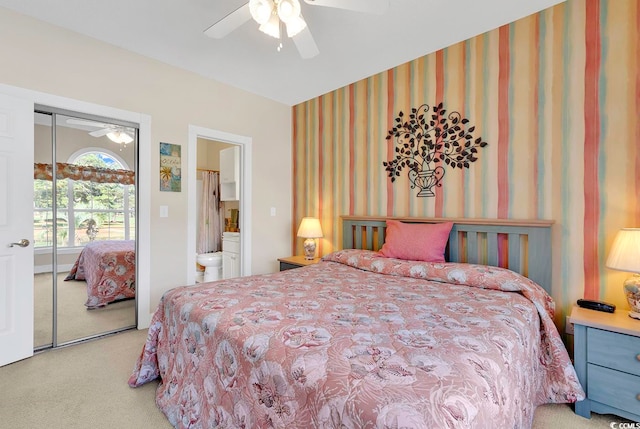 bedroom featuring ceiling fan, a closet, and light colored carpet