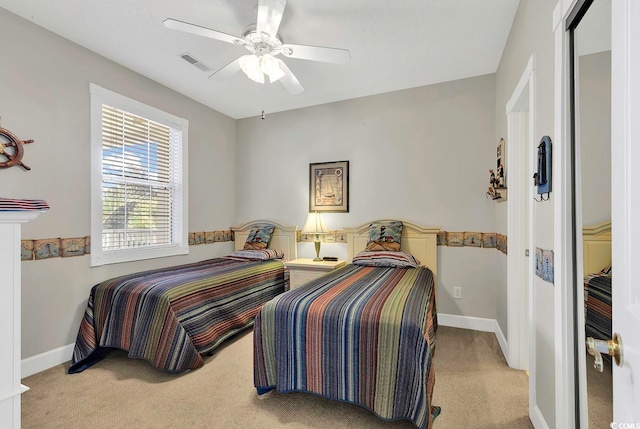 carpeted bedroom with ceiling fan