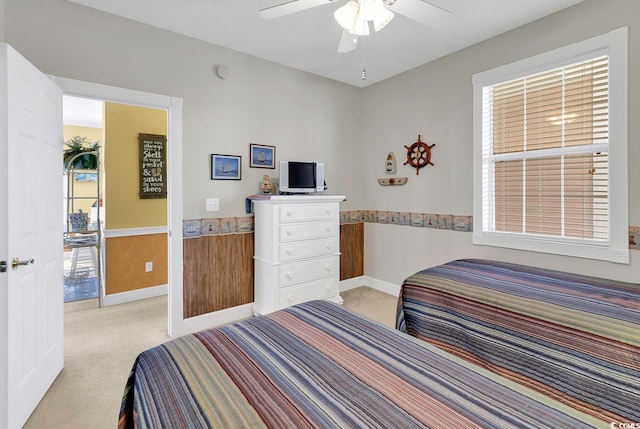 bedroom featuring ceiling fan and light carpet