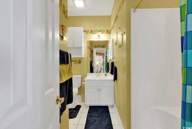 bathroom with toilet, vanity, a shower with shower curtain, and tile patterned floors