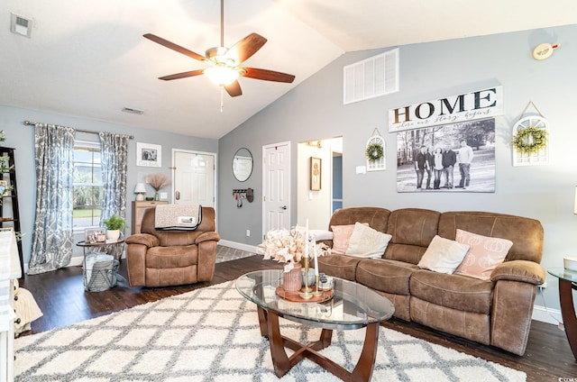 living room featuring dark hardwood / wood-style floors, ceiling fan, and vaulted ceiling