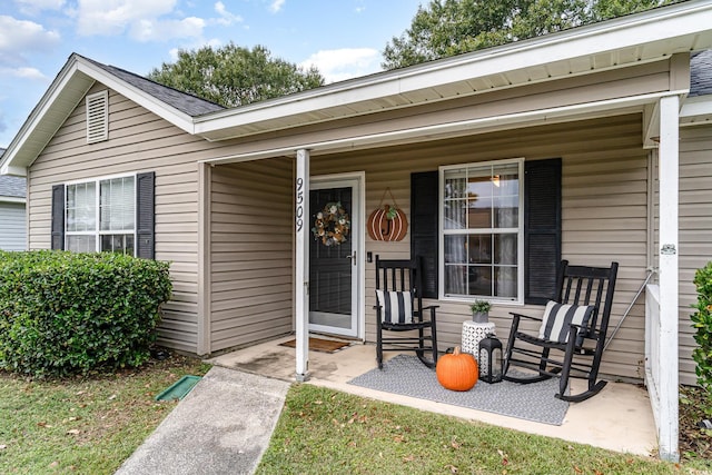 view of exterior entry with covered porch