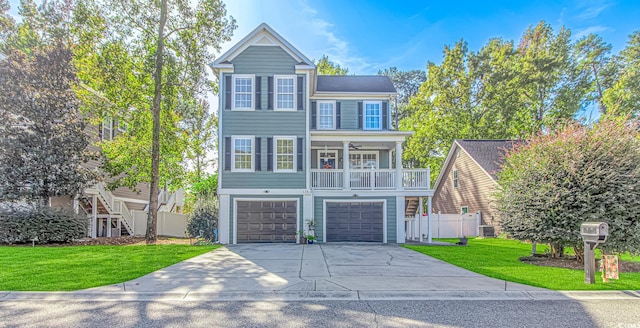 front facade featuring a garage, a front yard, and covered porch