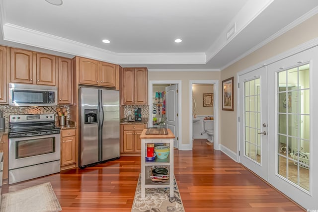 kitchen with dark wood-style floors, visible vents, french doors, appliances with stainless steel finishes, and a raised ceiling