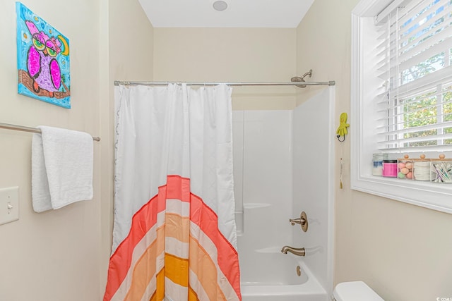 bathroom with toilet and shower / bath combo