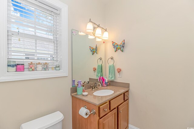 bathroom featuring vanity and toilet