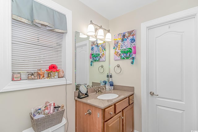 bathroom featuring toilet and vanity