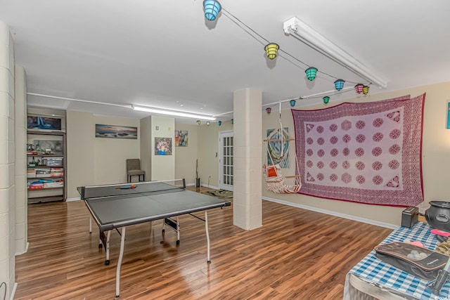 game room with baseboards and wood finished floors