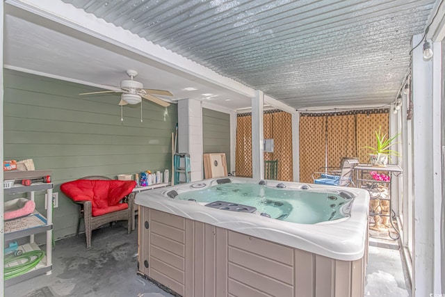 view of patio with ceiling fan and a hot tub