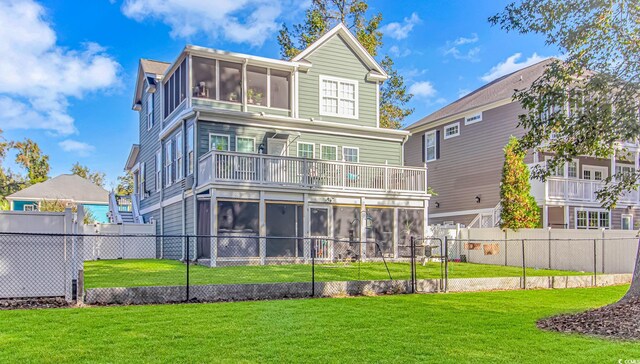 back of house with a lawn and a sunroom