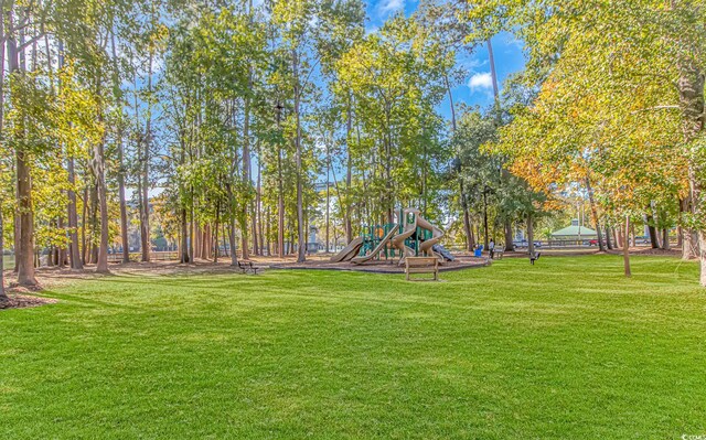 view of community featuring a playground and a lawn