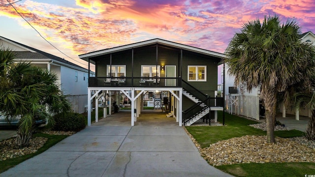 beach home with a porch and a carport