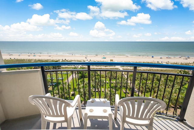 balcony with a water view and a beach view