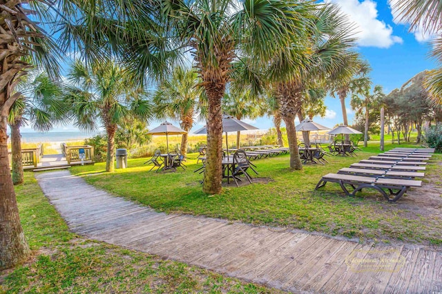 view of property's community with a water view, a lawn, and a gazebo