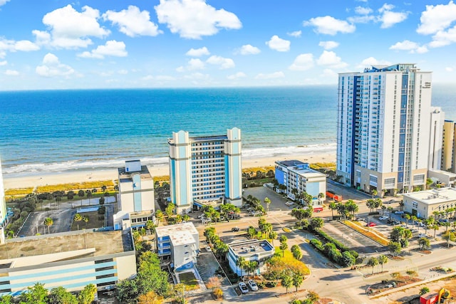 birds eye view of property with a beach view and a water view