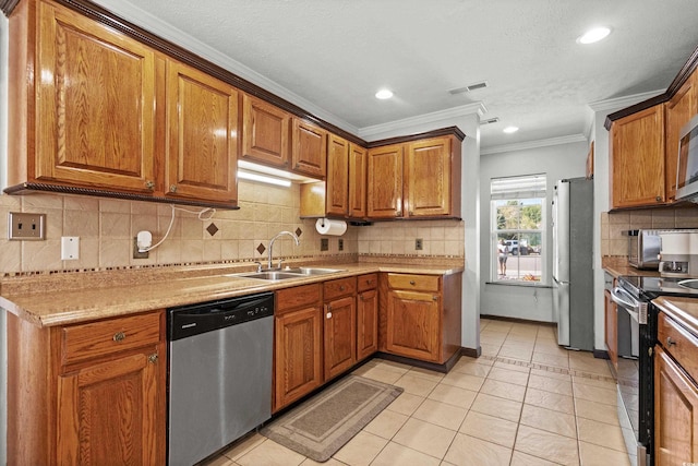 kitchen featuring backsplash, sink, ornamental molding, light tile patterned flooring, and stainless steel appliances