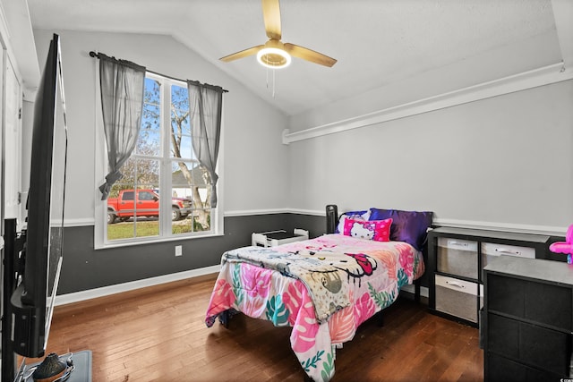 bedroom with ceiling fan, dark hardwood / wood-style floors, and vaulted ceiling