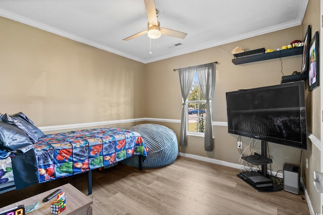 bedroom with hardwood / wood-style flooring, ceiling fan, and ornamental molding