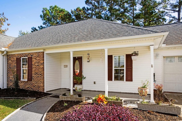 view of front facade with covered porch and a garage