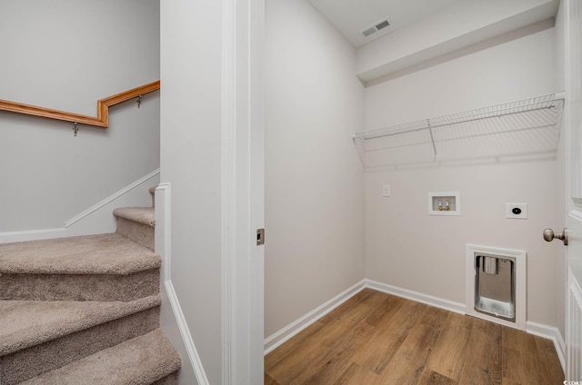 clothes washing area with hookup for an electric dryer, hookup for a washing machine, and hardwood / wood-style flooring